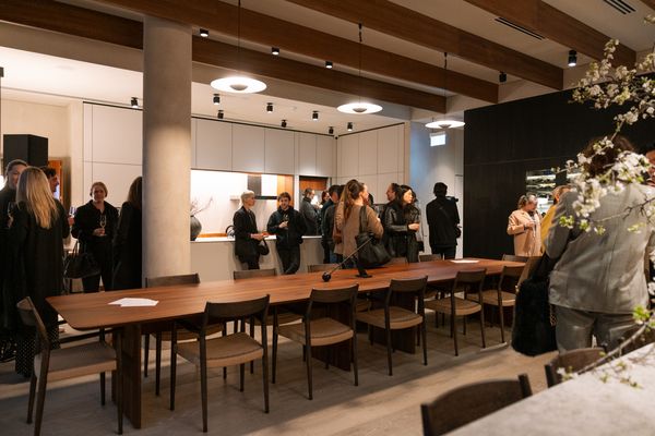 A group of people socialising in a kitchen showroom at the Gaggenau KOTY Awards.