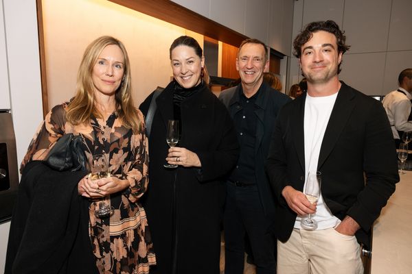 Four people posing for a photo with drinks at the Gaggenau KOTY Awards.