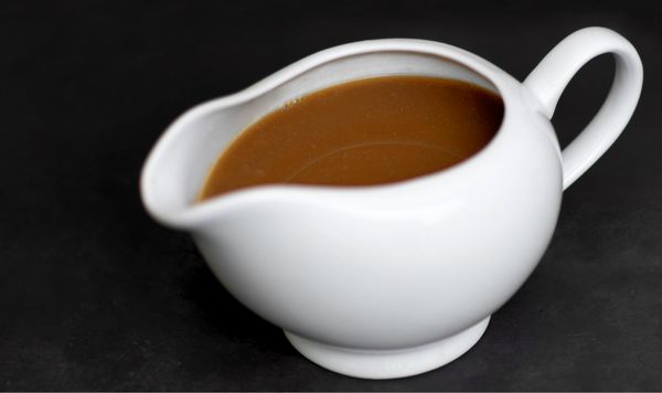 A white jug filled with turkey gravy