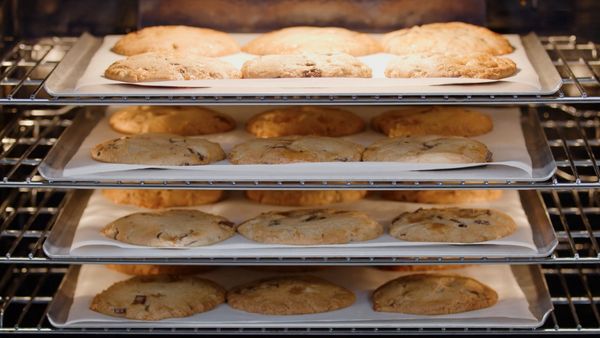 Four racks of cookies baking in a Gaggenau convection oven