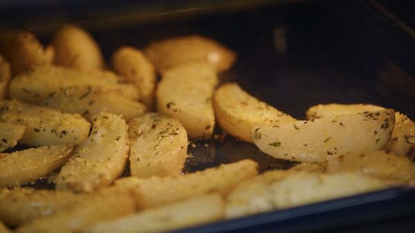 Vegetables roasting in a blue Gaggenau oven tray 