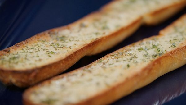 Garlic bread crisping in a blue Gaggenau oven tray 