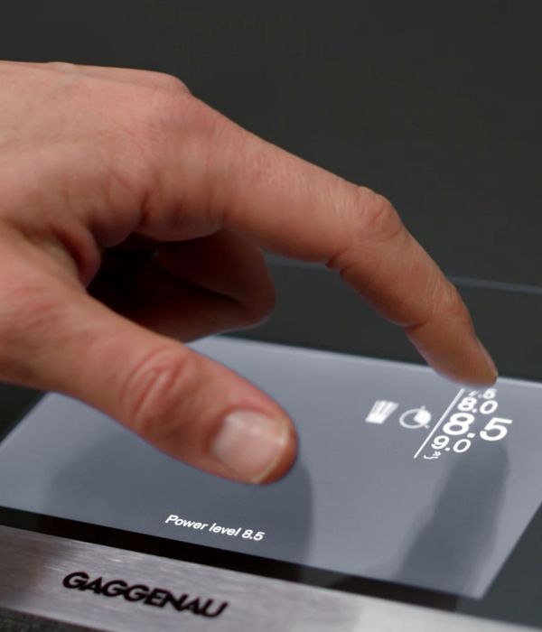 Chef selecting the power level on the Gaggenau full surface induction cooktop