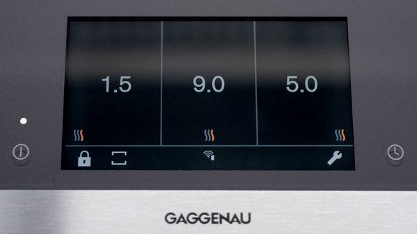 Close-up of the Gaggenau full surface induction cooktop touch screen in Professional Cooking mode, with the three different heat settings across the whole cooktop surface.