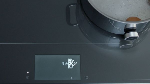 Plan view of the Gaggenau full surface induction cooktop showing a cooking sensor attached to a pan.