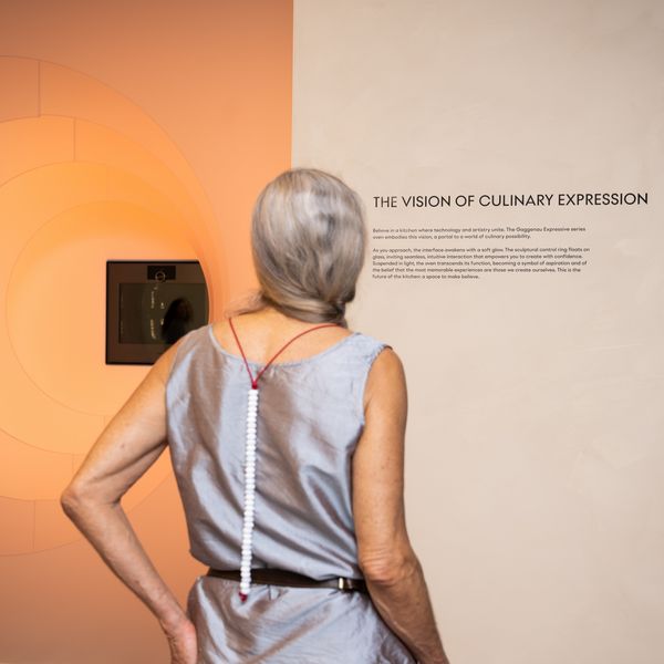 A visitor pausing to read part of the Believe. section of the Expressive dialogue exhibition at Design Miami 2025