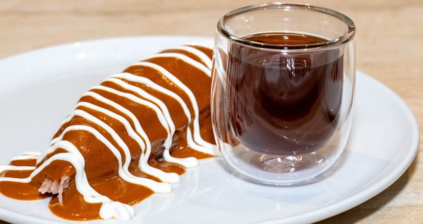 Chicken confit red tamal paired with warm Portola coffee.