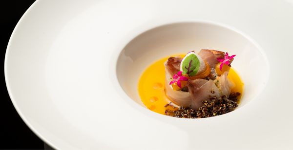 Another dish, delicately decorated with petite edible flowers.