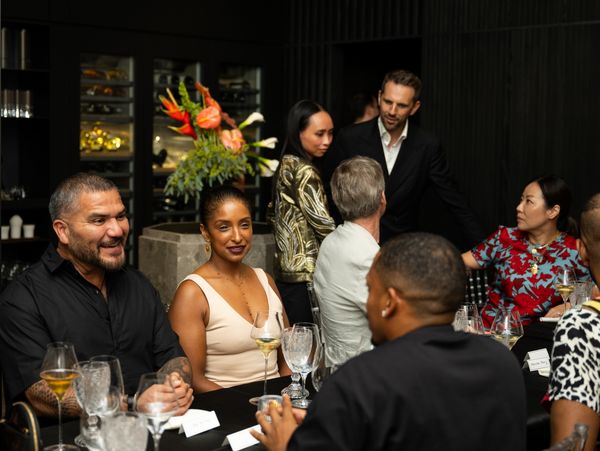 Guests seated at the table, talking and laughing. 