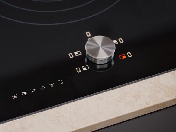Close-up view of the twist knob of a CI induction cooktop