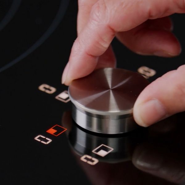 Close-up view of the twist knob of a CI induction cooktop