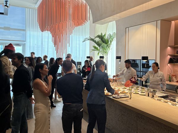 Guests mingling and chatting while food is served.