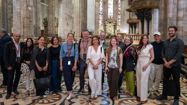 Tour guests posing inside of the Duomo di Milano.