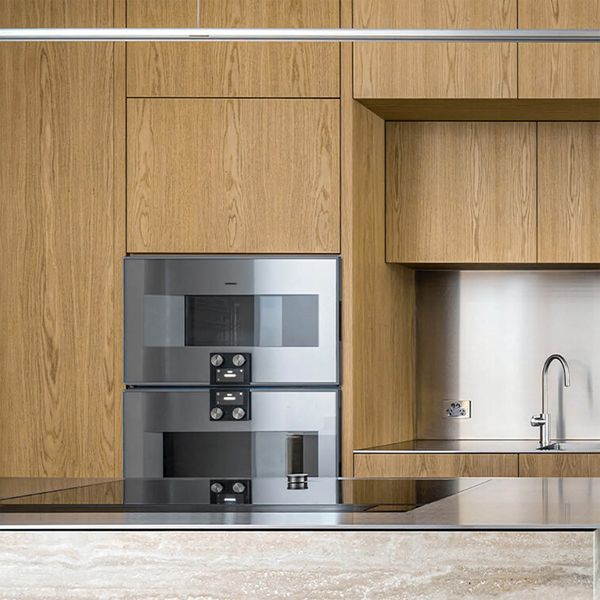 Gaggenau appliances installed in a luxury dark kitchen with island worktop