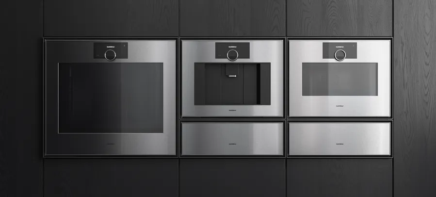 Gaggenau Expressive series appliances fitted in a dark wood luxury kitchen interior